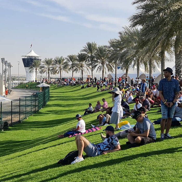 Fans on the Abu Dhabi Hill lawn beside the circuit, Shams Tower behind