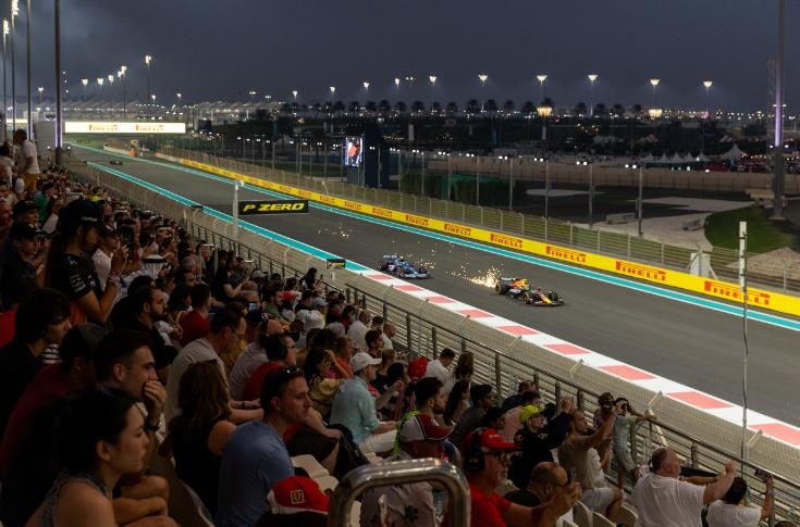 Night racing along the West Straight at Yas Marina Circuit