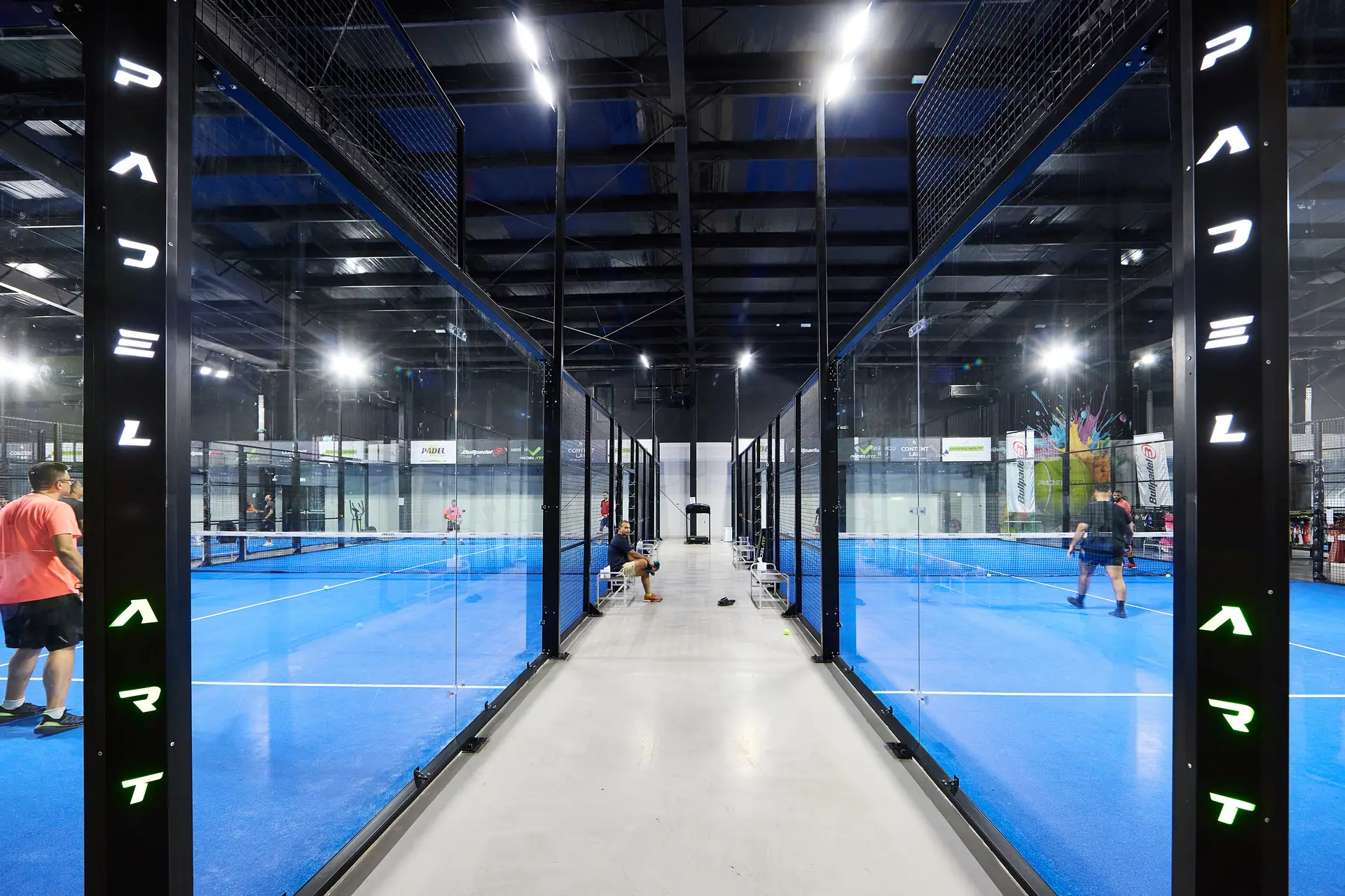 The club floor at Padel Art with branded court glass