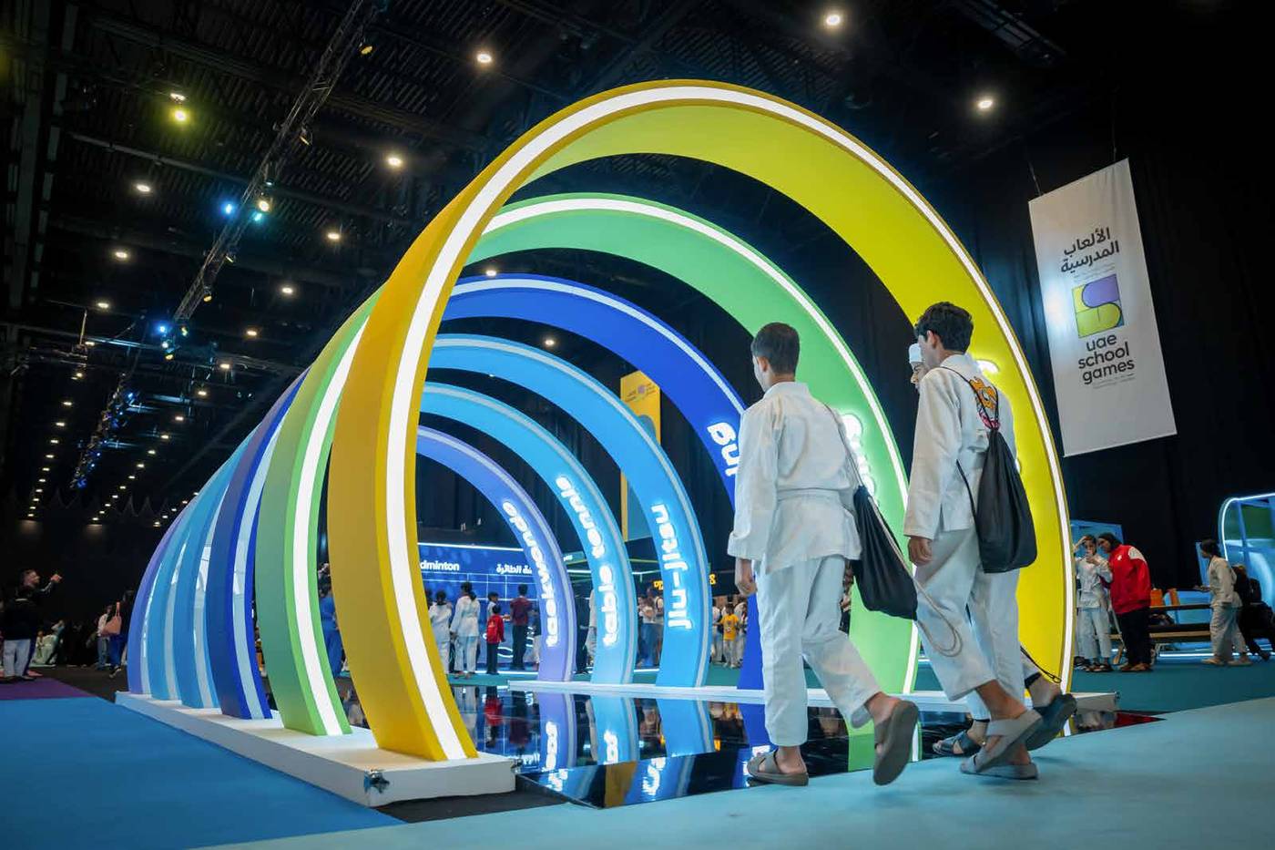 Students walking through the UAE School Games arrival arches