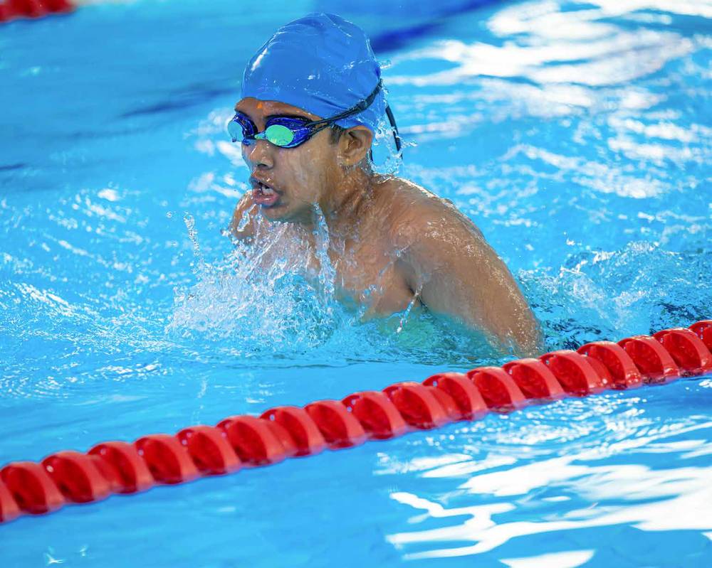 Swimmer mid-race at the UAE School Games