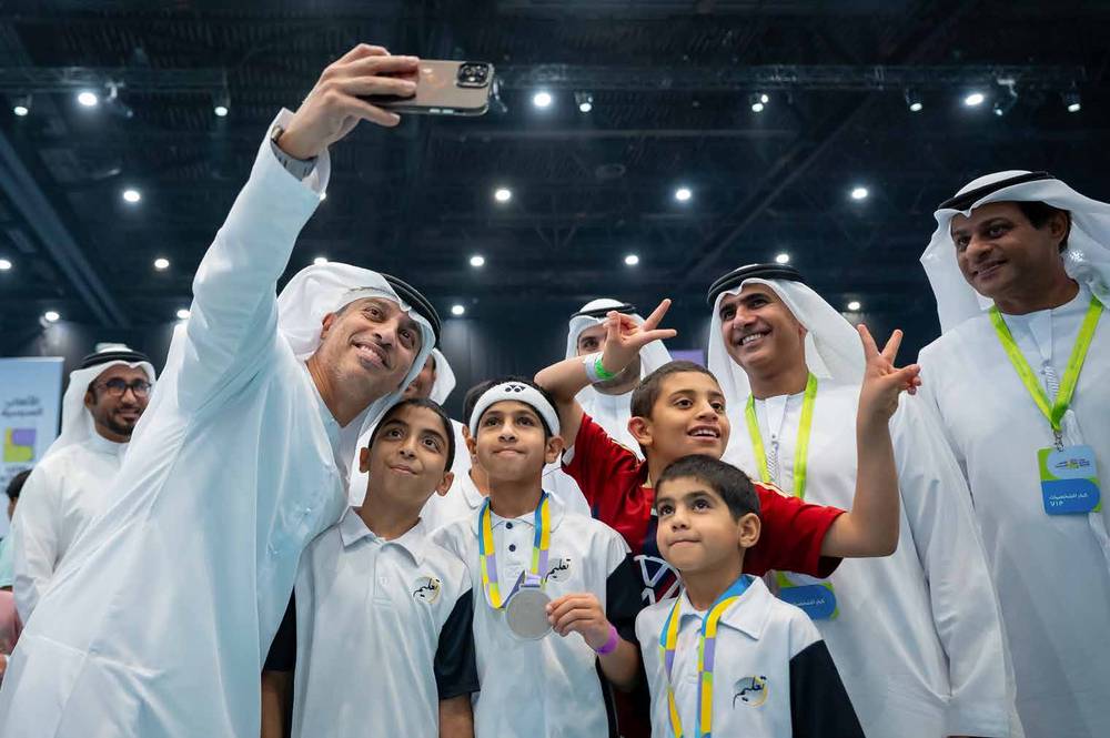 Officials taking a selfie with medal-winning students