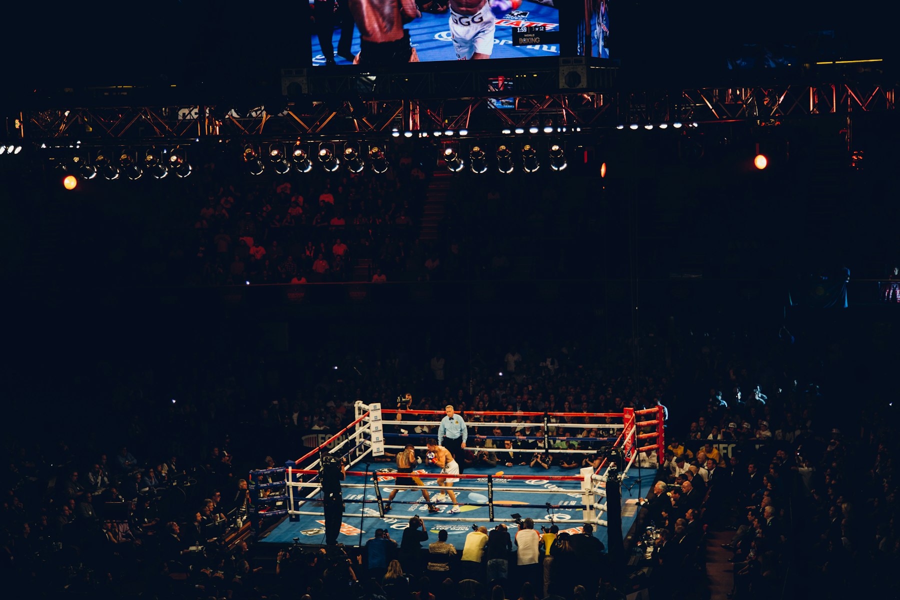 A title fight under the lights in a packed boxing arena