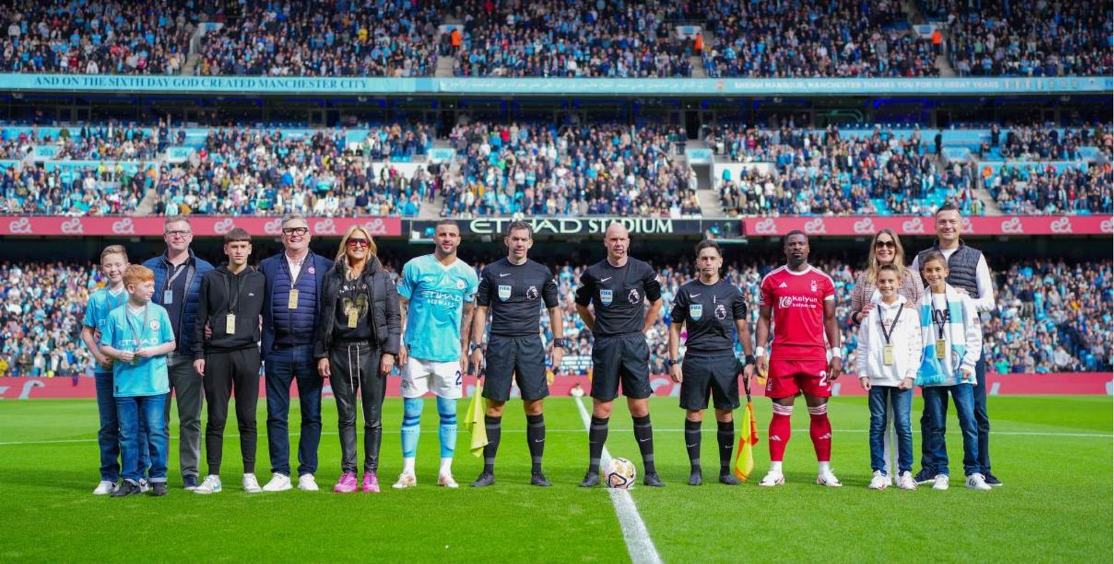 Guests on the centre circle with the captain and match officials at the Etihad Stadium