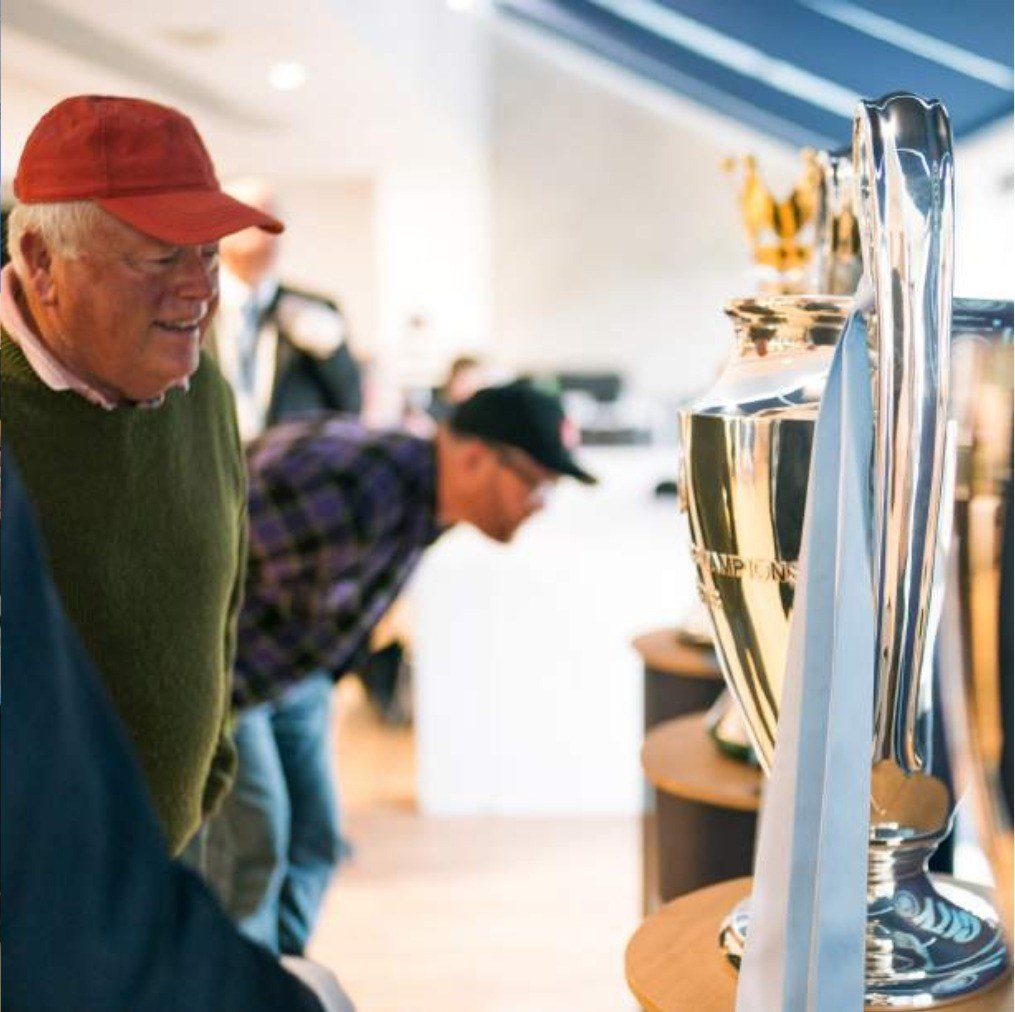 A guest viewing the Premier League trophy in the trophy room