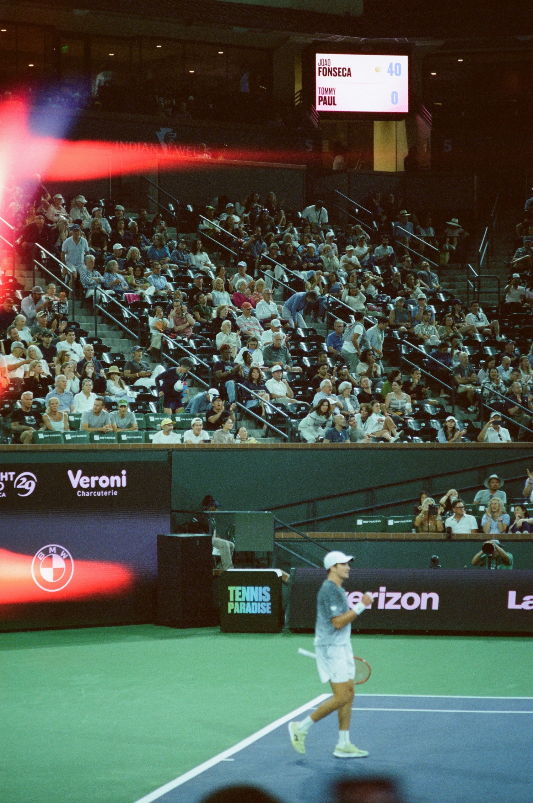 Spectators courtside at a professional tennis match